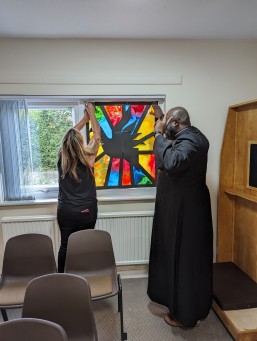Applying stained glass panels at St Augustine's