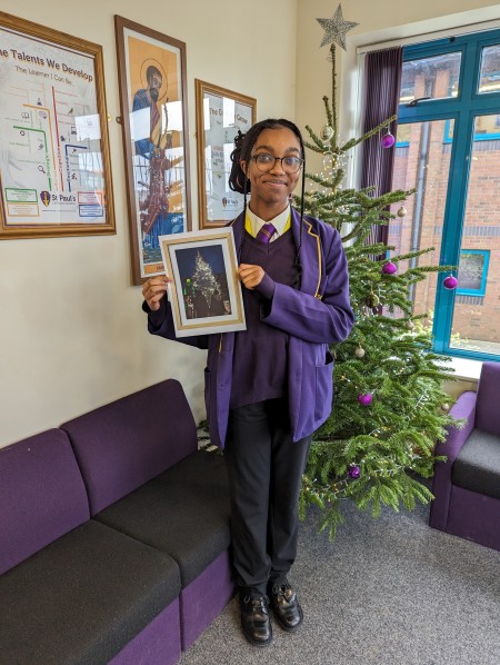Student holding winnin photography competition entry