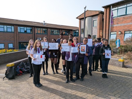 Students show their entries for the show racism the red card competition