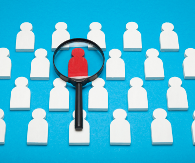 Silhouettes of people with magnifying glass
